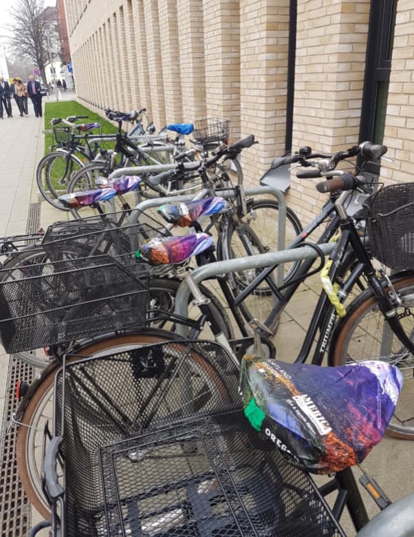 Portland Region-branded bicycle seat covers adorn every bike in a bike rack.