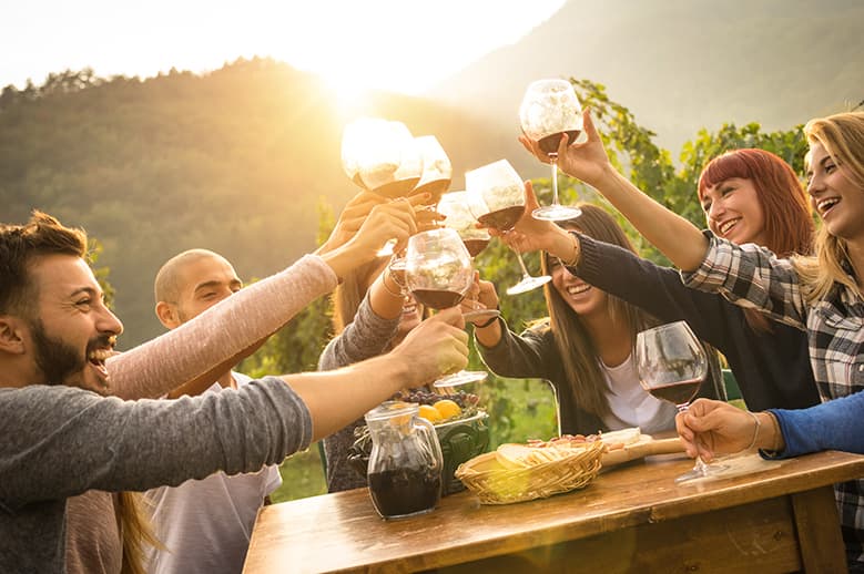 A group of people raising wine glasses in a toast.