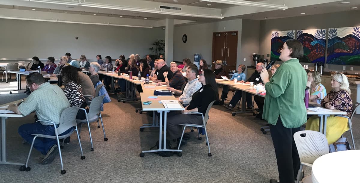 A speaker presenting to a room of attendees at one of the regional training workshops.